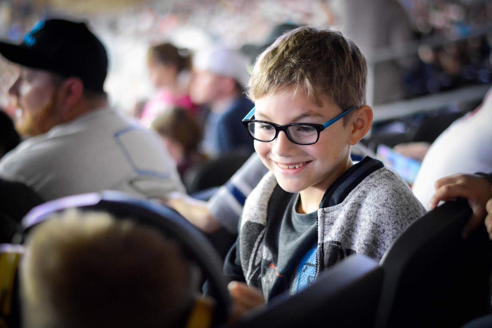 Brayden smiling in the stands at a game